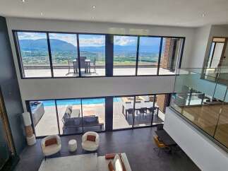 Experience luxurious living in this modern architectural masterpiece, boasting expansive floor-to-ceiling windows that offer breathtaking panoramic views of the surrounding landscape.