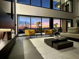 Experience luxury living in this modern home with stunning panoramic views.