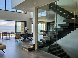 Experience luxury living in this modern architectural masterpiece, boasting expansive floor-to-ceiling windows that offer breathtaking panoramic views of the city and mountains.