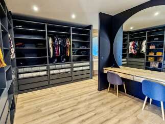 Step into this luxurious walk-in closet, designed for the discerning homeowner.