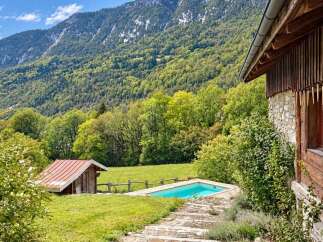 Escape to this charming mountain retreat featuring a rustic wooden cabin and a refreshing private pool.