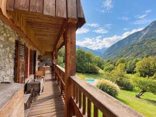 Experience rustic charm and breathtaking mountain views from this charming wooden balcony.