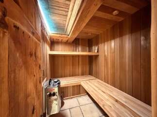 Experience ultimate relaxation in this luxurious wooden sauna, featuring a Harvia heater and spacious benches for ultimate comfort.