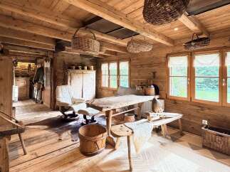 Experience rustic charm in this beautifully appointed wooden cabin, featuring exposed beams and a cozy, natural aesthetic.