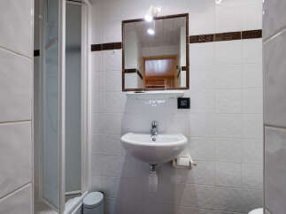 This bathroom features a modern shower stall with a glass door, perfect for a quick refresh.