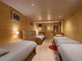 This charming bedroom features three twin beds, perfect for accommodating guests or a family.