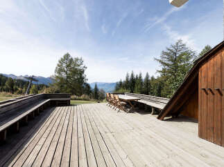 Enjoy breathtaking mountain views from this expansive wooden deck, perfect for outdoor dining and relaxation.