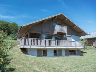 Experience modern mountain living in this stunning wooden chalet, featuring expansive balconies and large windows that capture breathtaking natural views.