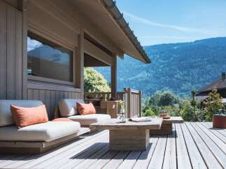 Experience breathtaking mountain views from this stunning wooden deck, perfect for outdoor entertaining or quiet relaxation.