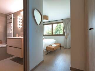Experience modern comfort in this beautifully appointed bedroom and adjoining bathroom.