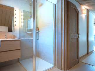 Experience modern luxury in this bathroom featuring a sleek vanity and a spacious glass-enclosed shower.