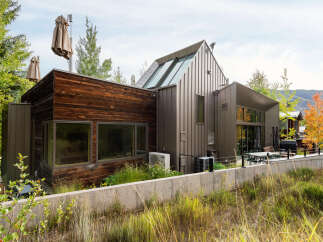 Experience modern mountain living in this stunning home featuring a unique blend of natural wood and sleek metal siding.