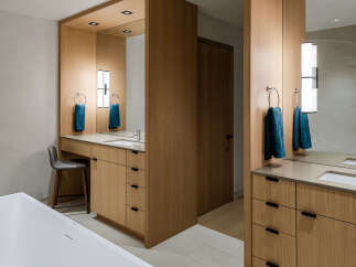 Experience modern luxury in this stunning bathroom, featuring a freestanding soaking tub and a sleek vanity with ample storage.
