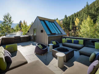 Experience ultimate relaxation on this stunning rooftop deck, complete with a steaming hot tub and ample seating areas.