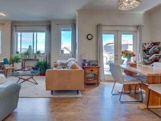Step into this inviting living and dining area, featuring a cozy leather sofa and a stylish dining set perfect for entertaining.