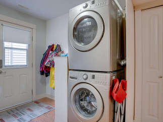 This laundry room features a stacked LG washer and dryer set, maximizing space efficiency.
