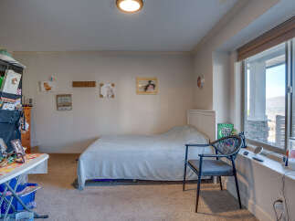 This charming bedroom features a comfortable bed with a light blue comforter, perfect for a restful night's sleep.