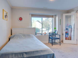 This charming bedroom features a comfortable bed with a light blue comforter, perfect for relaxation.