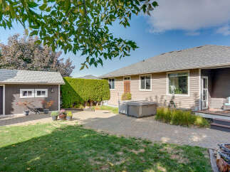 Enjoy outdoor living in this spacious backyard featuring a paved patio area perfect for entertaining.