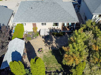 Discover this charming property featuring a spacious backyard perfect for entertaining, complete with a paved patio and a relaxing hot tub.