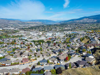 Experience the charm of this picturesque suburban neighborhood, nestled against rolling hills and offering breathtaking views of the distant mountains and a serene lake.