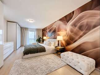 Experience modern luxury in this stunning bedroom featuring a statement accent wall with a captivating abstract design.