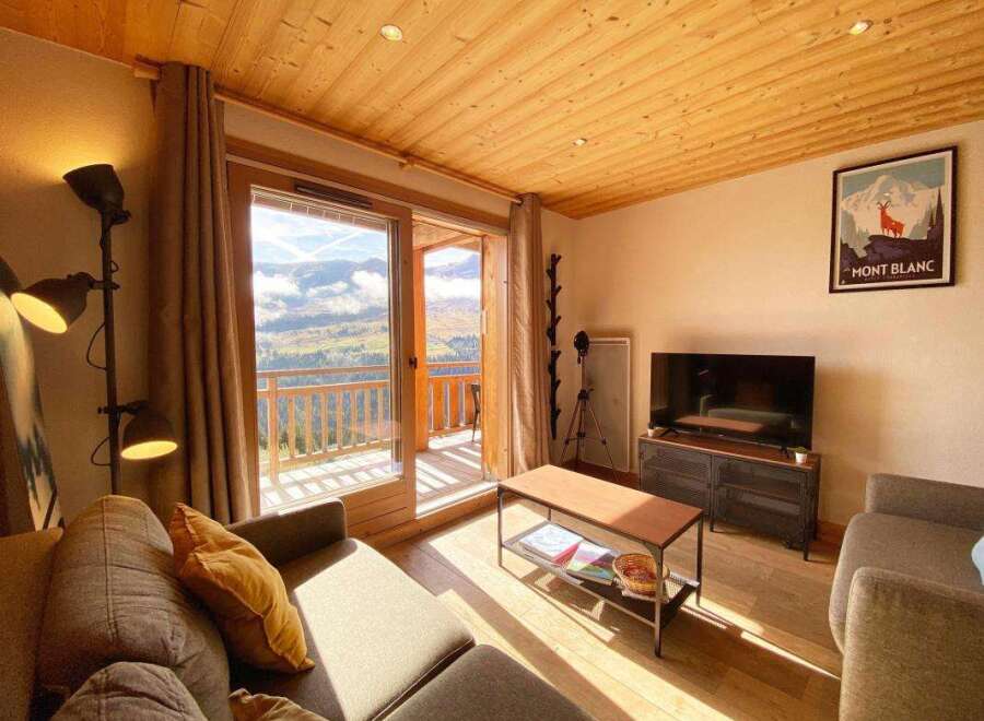 Experience breathtaking mountain views from this cozy living room, featuring a large sliding glass door that opens to a private balcony.