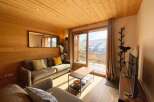 Experience cozy living in this charming mountain retreat, featuring warm wooden interiors and a spacious living area.