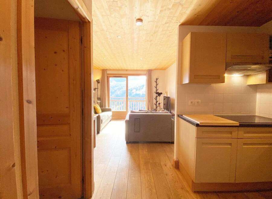 Experience breathtaking mountain views from this charming apartment, featuring a cozy living area with ample natural light and a well-equipped kitchen perfect for preparing meals.