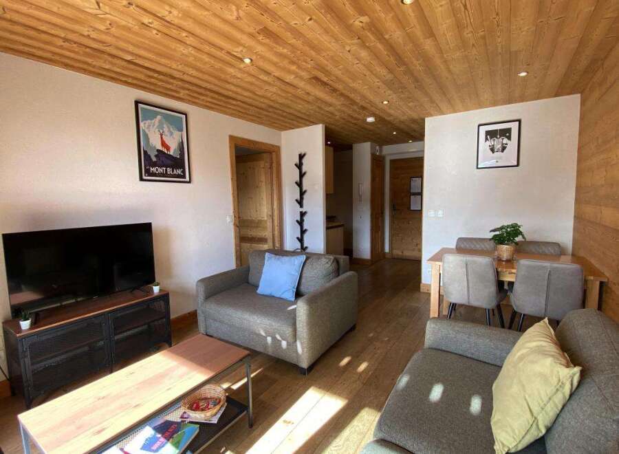 Experience the charm of this inviting living space, featuring a cozy seating area with plush sofas and a modern entertainment center.