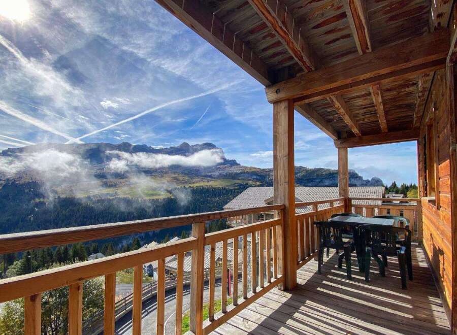 Enjoy breathtaking mountain views from this charming wooden balcony, perfect for your morning coffee or evening relaxation.