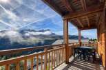 Enjoy breathtaking mountain views from this charming wooden balcony, perfect for your morning coffee or evening relaxation.