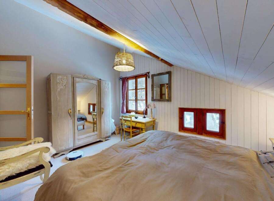 Discover this charming attic bedroom, perfect for a cozy retreat.