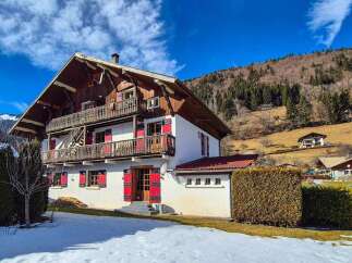 Experience the charm of this traditional chalet nestled in a picturesque mountain landscape.