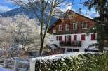 Experience the charm of this winter wonderland property, nestled against a backdrop of snow-capped mountains.