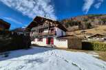 Experience the charm of this traditional alpine chalet, nestled against a backdrop of rolling hills and snow-dusted mountains.