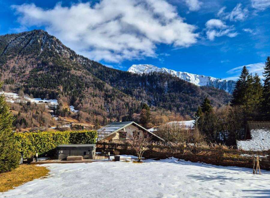 Experience the charm of mountain living in this picturesque property, nestled against a backdrop of majestic snow-capped peaks.