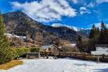 Experience the charm of mountain living in this picturesque property, nestled against a backdrop of majestic snow-capped peaks.