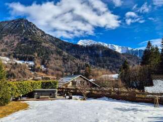 Experience the charm of mountain living in this picturesque property, nestled against a backdrop of majestic snow-capped peaks.