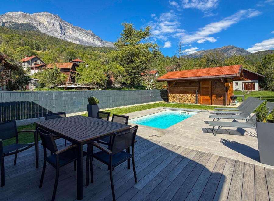 Enjoy a luxurious mountain retreat with this stunning property featuring a private swimming pool and a spacious outdoor dining area perfect for al fresco meals.