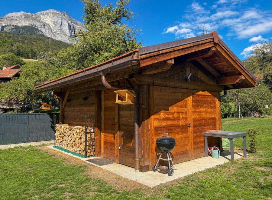 Discover this charming wooden shed, perfect for storage or as a garden retreat.
