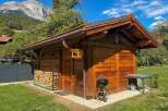 Discover this charming wooden shed, perfect for storage or as a garden retreat.