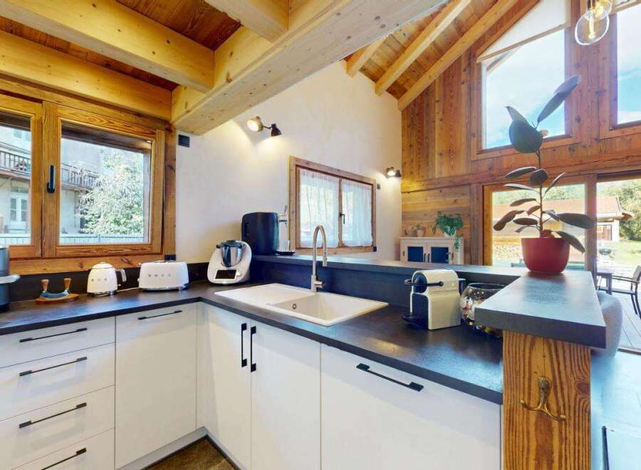 Experience modern living in this stunning kitchen featuring sleek white cabinetry and a spacious countertop.