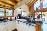 Experience modern living in this stunning kitchen featuring sleek white cabinetry and a spacious countertop.