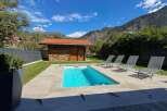 Escape to this stunning mountain retreat featuring a private swimming pool and ample lounge chairs for ultimate relaxation.