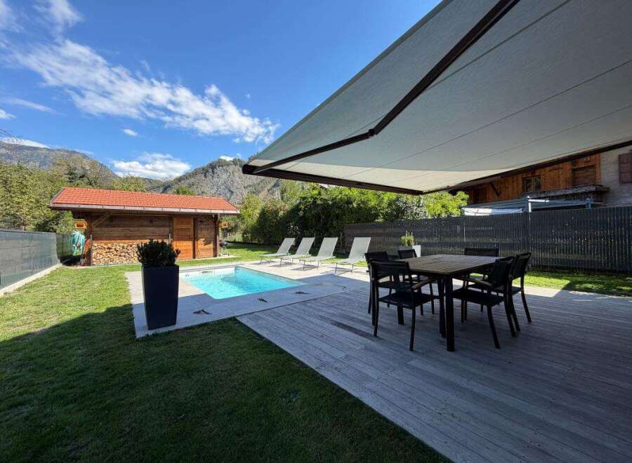Enjoy the ultimate outdoor living experience with this stunning property featuring a sparkling swimming pool and a spacious wooden deck perfect for entertaining.