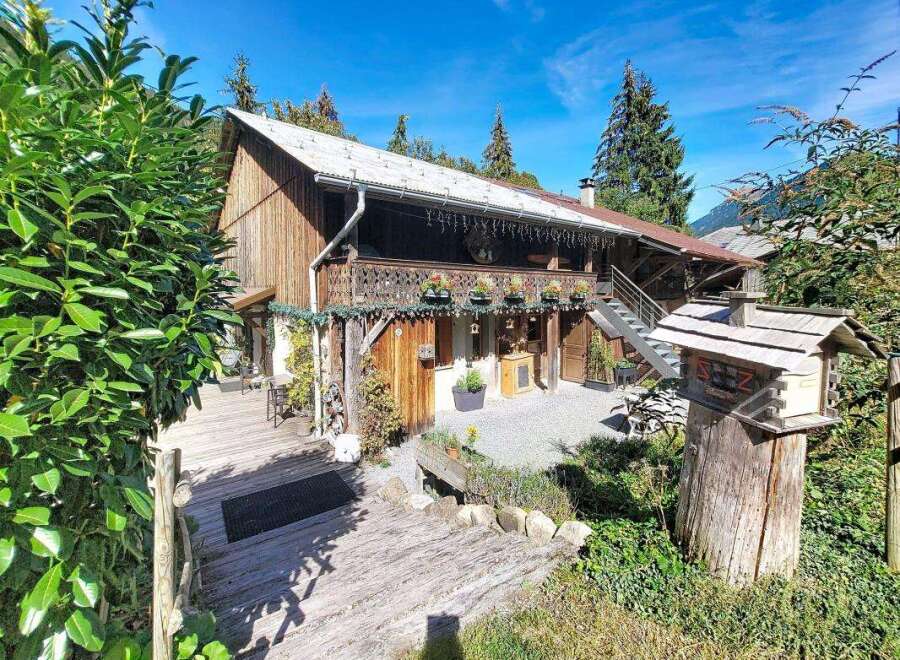 Experience rustic charm in this traditional wooden chalet, nestled amidst lush greenery and offering a picturesque mountain view.