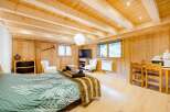 Experience cozy mountain living in this charming studio apartment, featuring a comfortable bed, a compact kitchenette with a microwave and kettle, and a dining area perfect for two.
