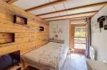 This cozy bedroom features a comfortable bed with a nature-inspired duvet cover, perfect for a restful night's sleep.