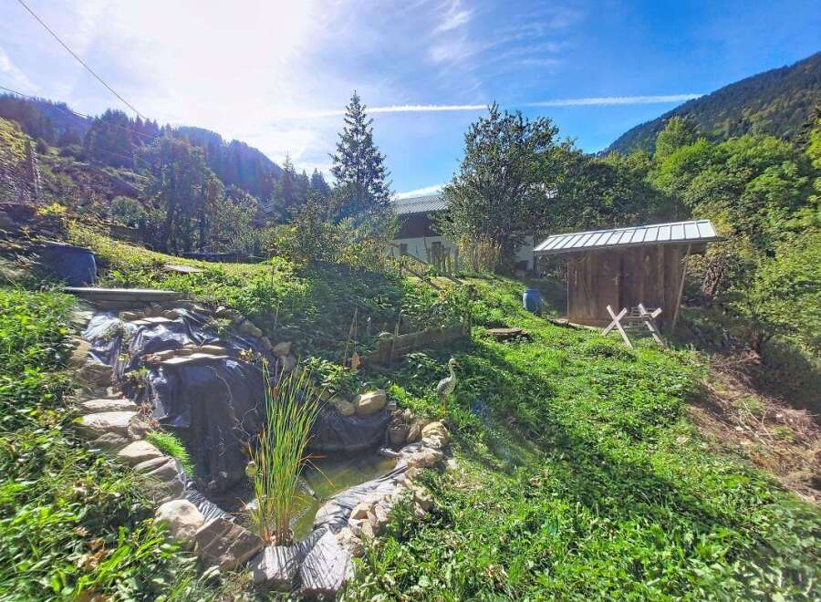 Discover this charming property nestled in a serene, mountainous landscape.